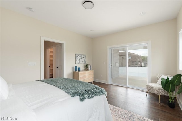 bedroom featuring access to exterior and hardwood / wood-style floors