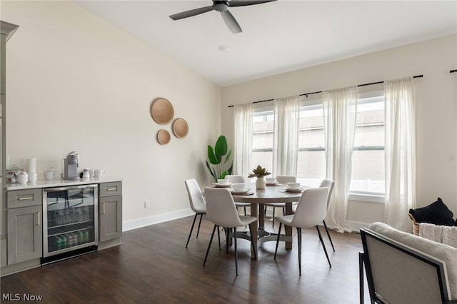 dining room with lofted ceiling, ceiling fan, dark hardwood / wood-style floors, wine cooler, and bar area