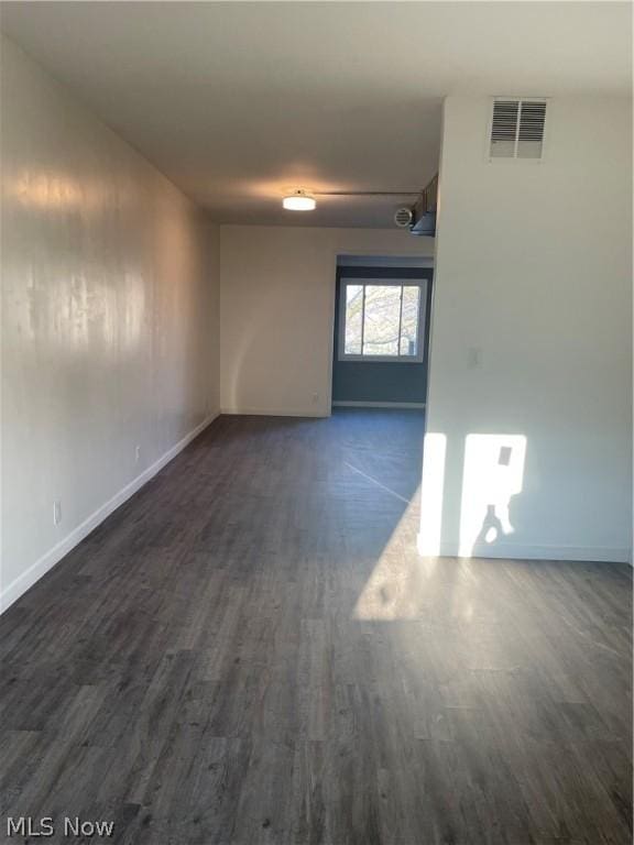 spare room featuring dark hardwood / wood-style flooring