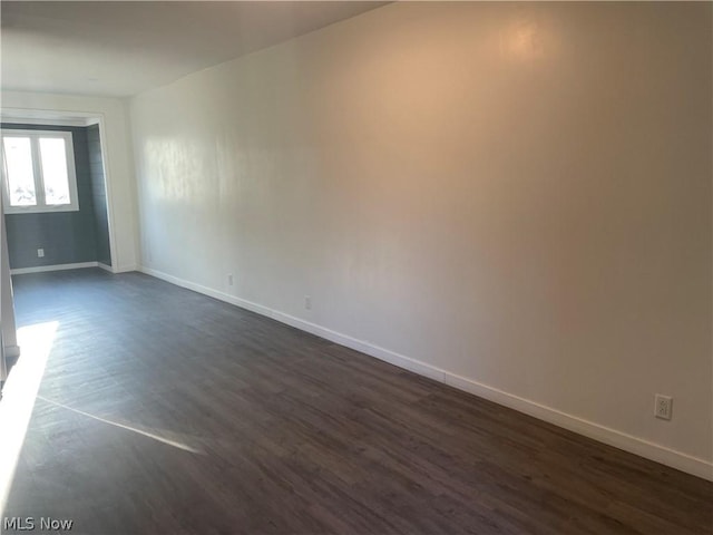 empty room with dark hardwood / wood-style floors