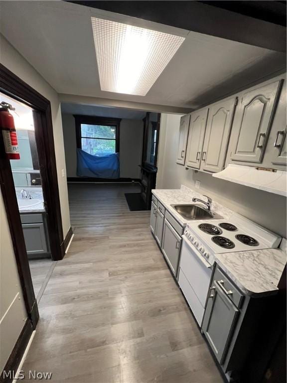 kitchen featuring sink, white electric range oven, and gray cabinetry