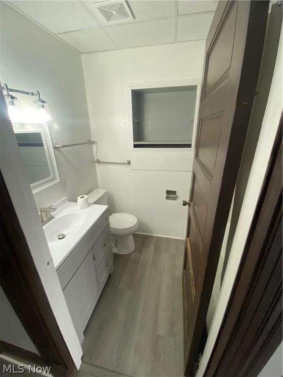 bathroom featuring hardwood / wood-style flooring, vanity, and toilet