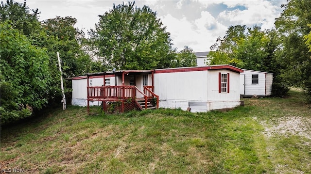 back of house with a yard and a deck