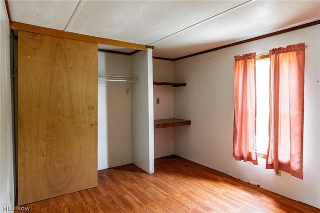 unfurnished bedroom featuring a closet and light hardwood / wood-style flooring