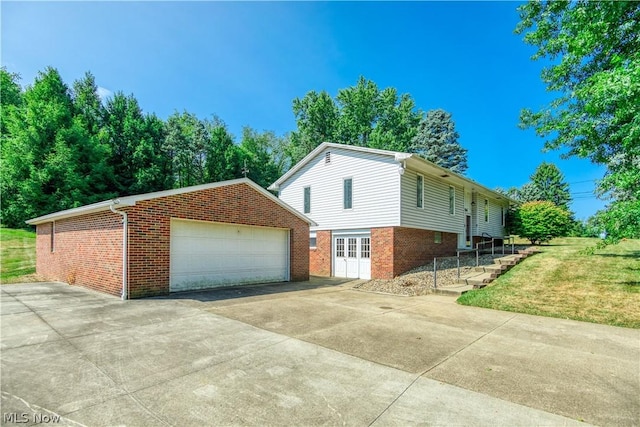 view of property exterior featuring a yard, a garage, and an outdoor structure