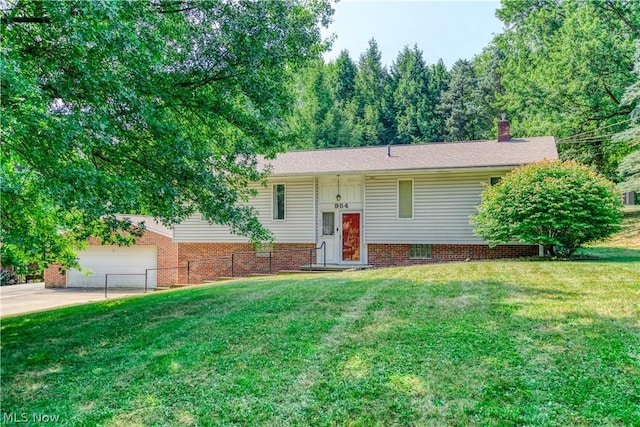 raised ranch with a garage and a front lawn