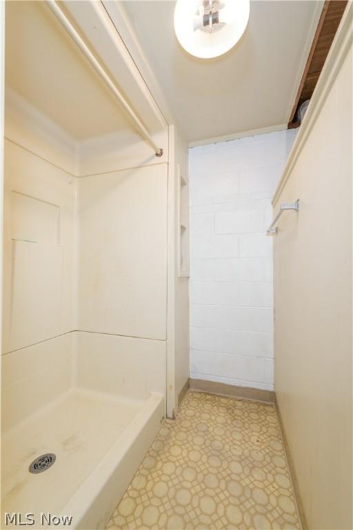 bathroom featuring tile patterned flooring and walk in shower