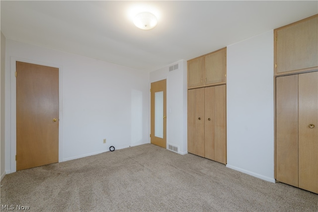 unfurnished bedroom with light colored carpet