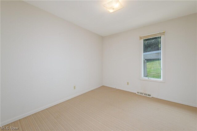 empty room with light colored carpet