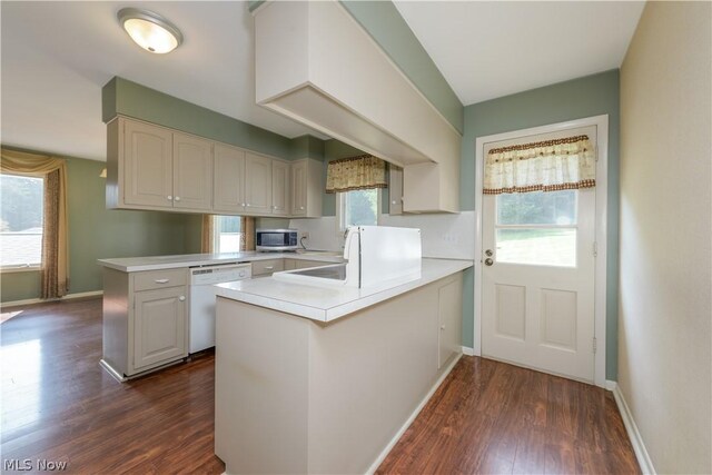 kitchen featuring white cabinets, dishwasher, dark hardwood / wood-style flooring, and kitchen peninsula