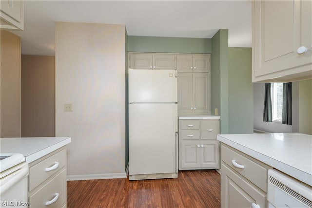 kitchen featuring white cabinets, dark hardwood / wood-style floors, white fridge, and stove