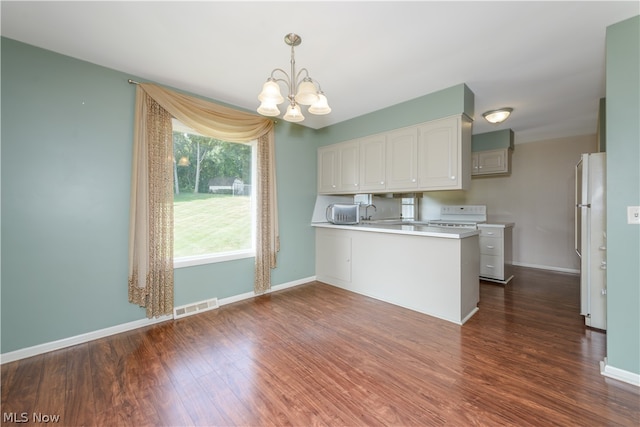 kitchen with decorative light fixtures, dark hardwood / wood-style flooring, kitchen peninsula, and a chandelier