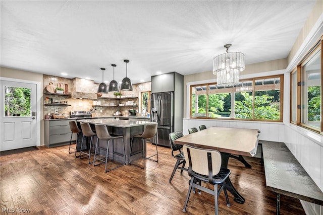 dining room featuring a notable chandelier, a wealth of natural light, and hardwood / wood-style floors