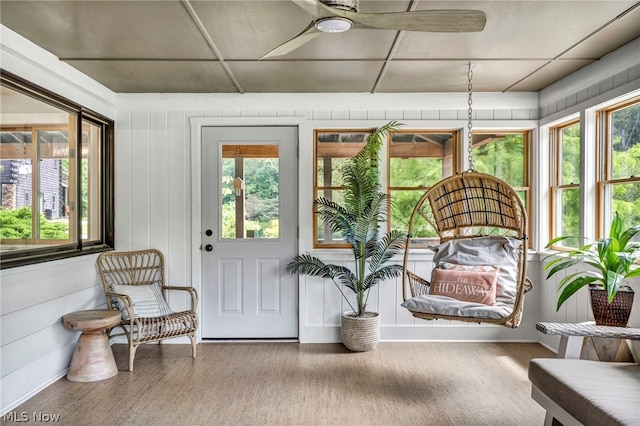 sunroom / solarium with plenty of natural light and ceiling fan