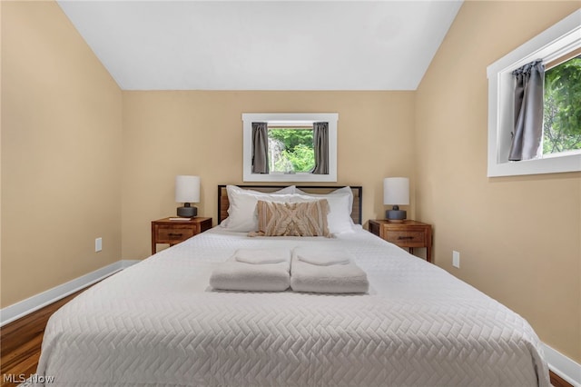 bedroom featuring wood-type flooring and vaulted ceiling