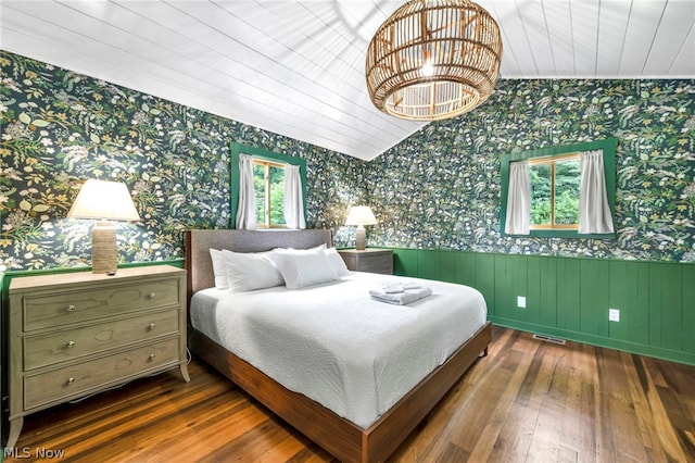 bedroom with hardwood / wood-style flooring and lofted ceiling