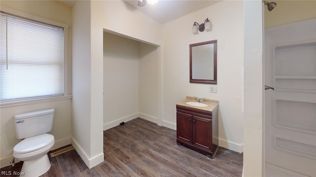 bathroom featuring vanity, toilet, and hardwood / wood-style floors