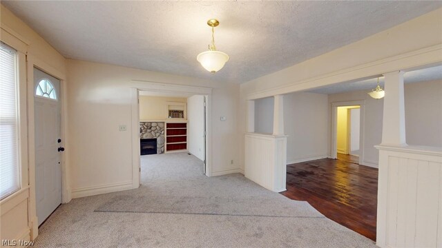 hall featuring a textured ceiling and carpet flooring