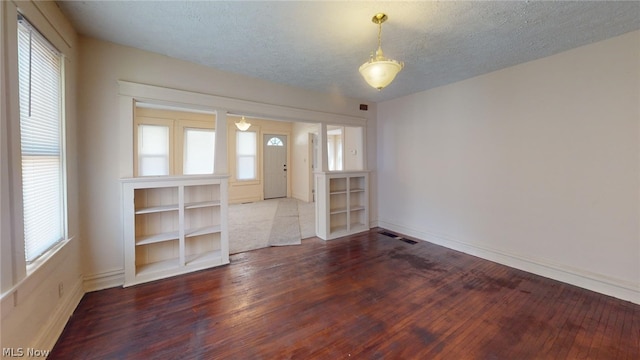 interior space with hardwood / wood-style flooring and a textured ceiling