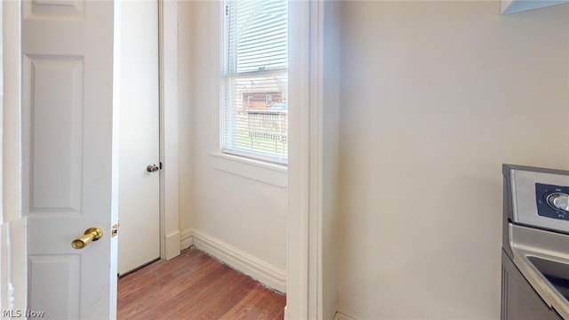 interior space featuring hardwood / wood-style flooring and washer / dryer