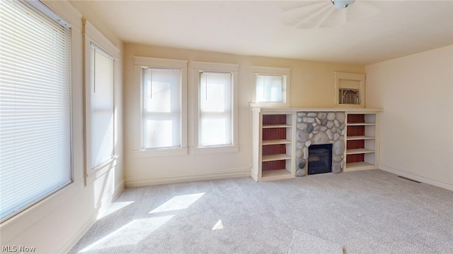 unfurnished living room with light carpet and a fireplace