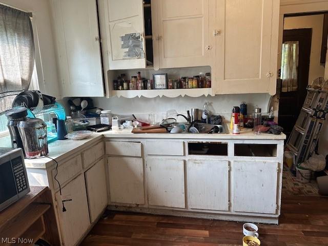 kitchen featuring white cabinetry, sink, and dark hardwood / wood-style flooring