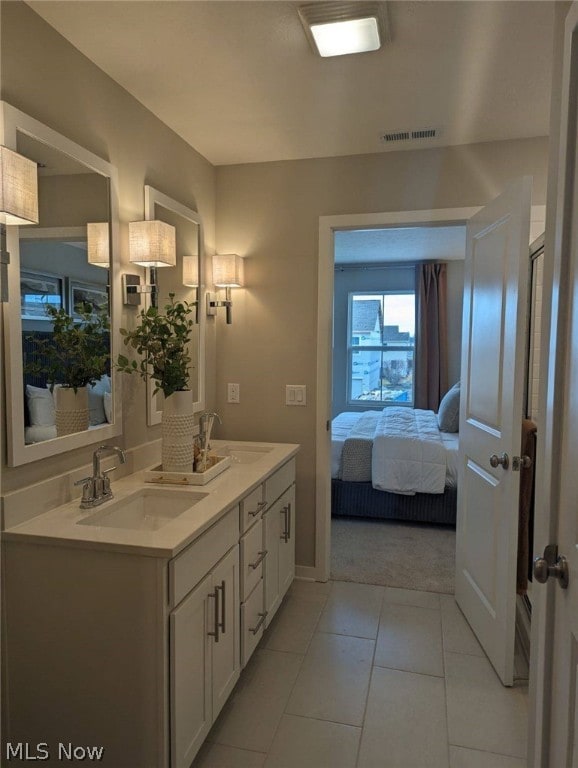 bathroom with vanity, tile patterned floors, and backsplash