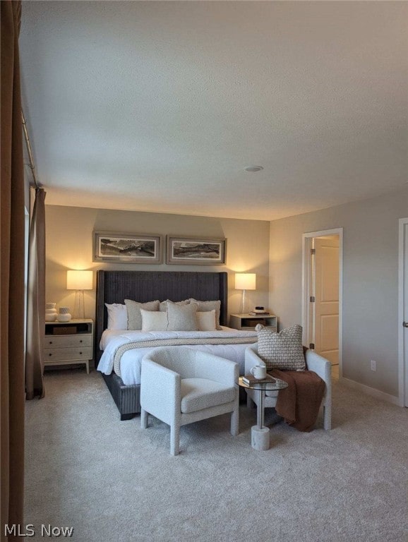 carpeted bedroom featuring a textured ceiling