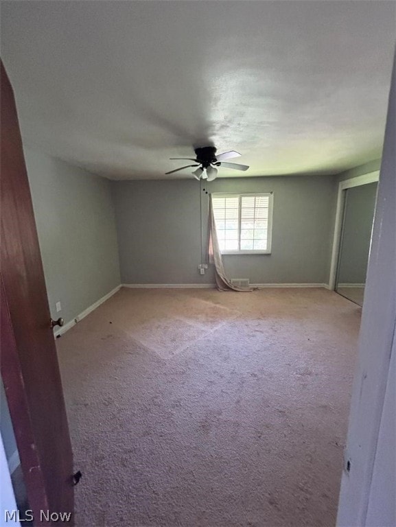 carpeted empty room with ceiling fan