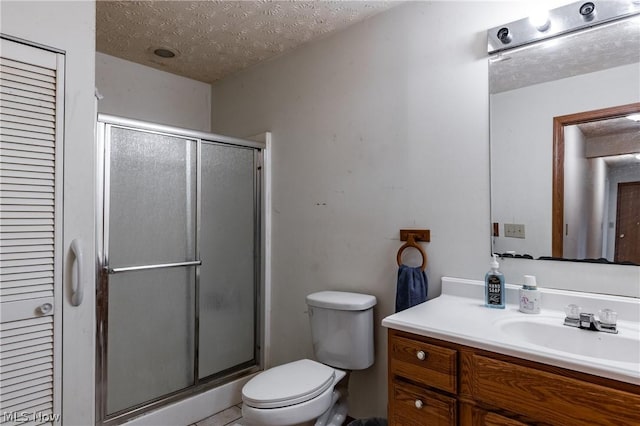 bathroom featuring vanity, toilet, a textured ceiling, and walk in shower