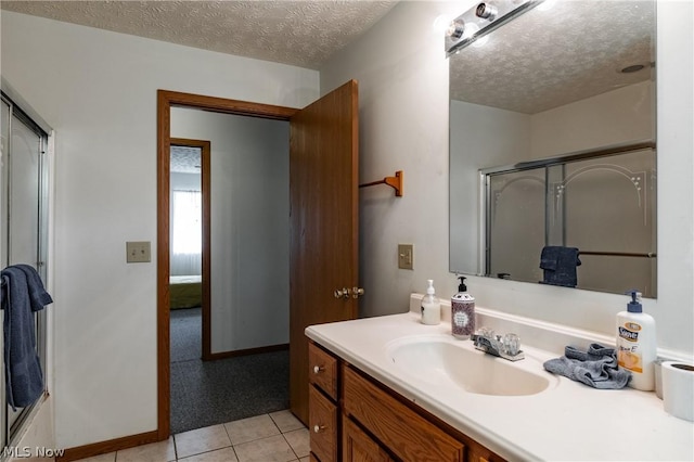 bathroom with vanity, tile patterned floors, and a textured ceiling