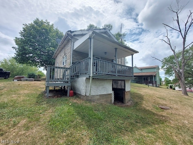 back of house with a lawn