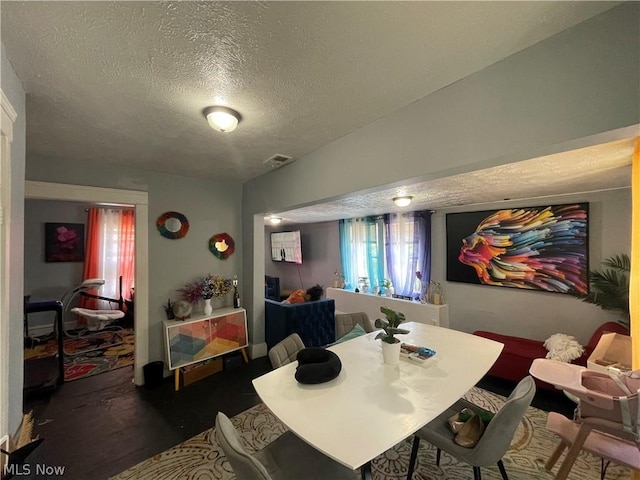 dining space featuring a textured ceiling