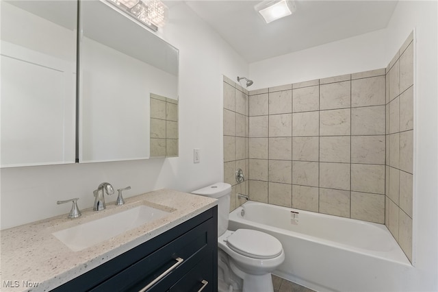 full bathroom with vanity, tiled shower / bath combo, and toilet