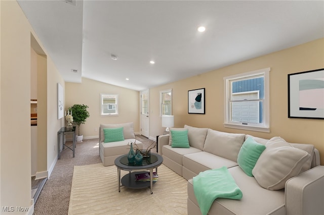 carpeted living room featuring lofted ceiling