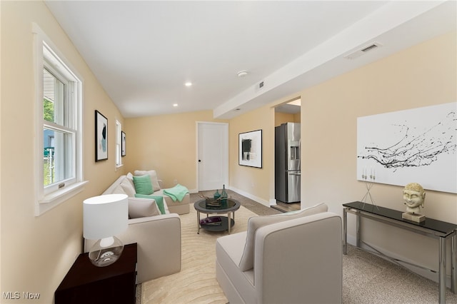 living room with light colored carpet and vaulted ceiling