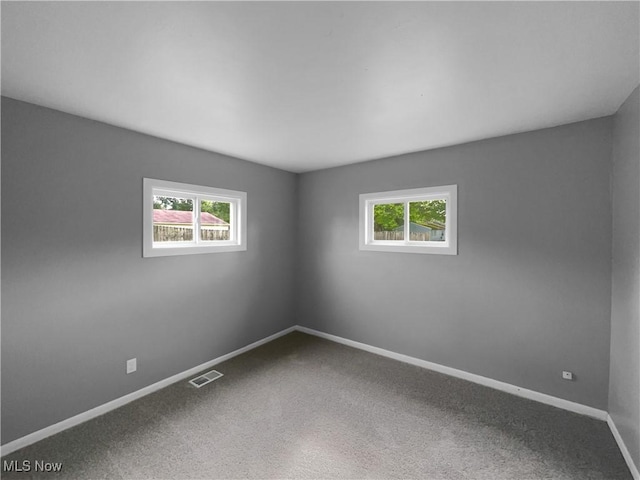 carpeted spare room with a healthy amount of sunlight