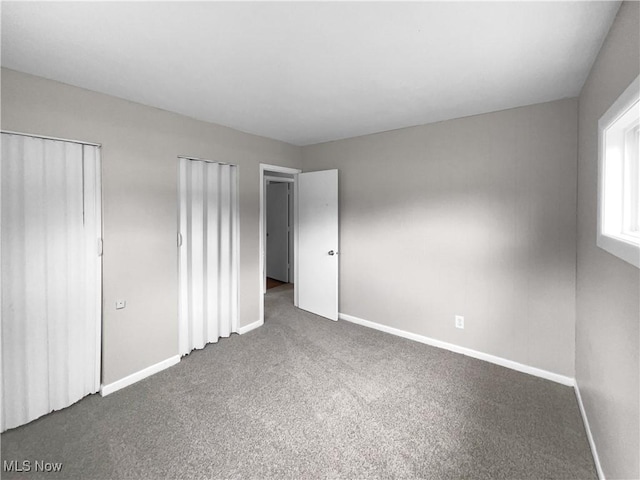 unfurnished bedroom featuring dark colored carpet