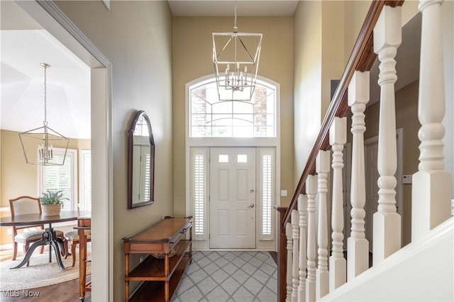 foyer entrance with a towering ceiling and plenty of natural light