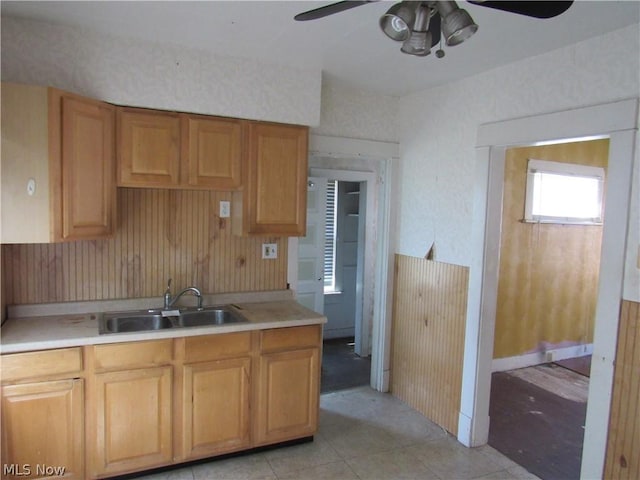 kitchen featuring light tile patterned flooring, light countertops, ceiling fan, and a sink