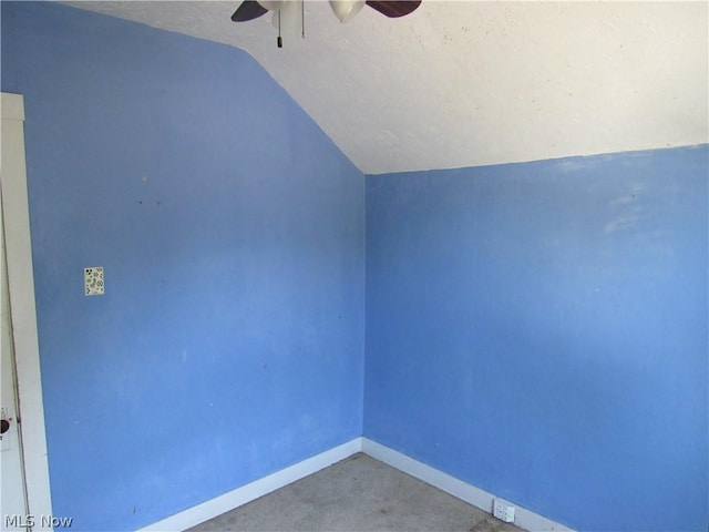 additional living space with carpet flooring, baseboards, lofted ceiling, and a ceiling fan