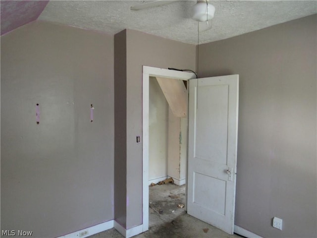 interior space featuring a textured ceiling, concrete flooring, and ceiling fan