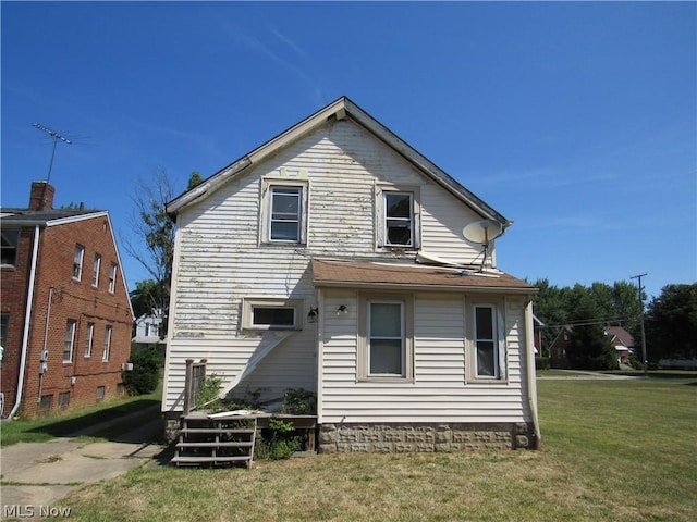 back of house with a lawn