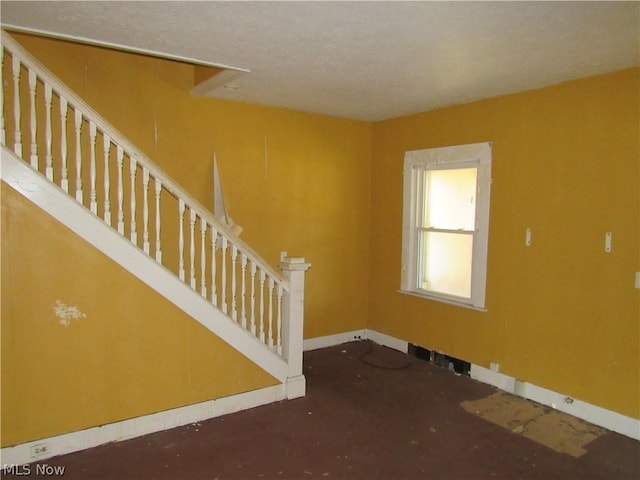 interior space with stairs and baseboards