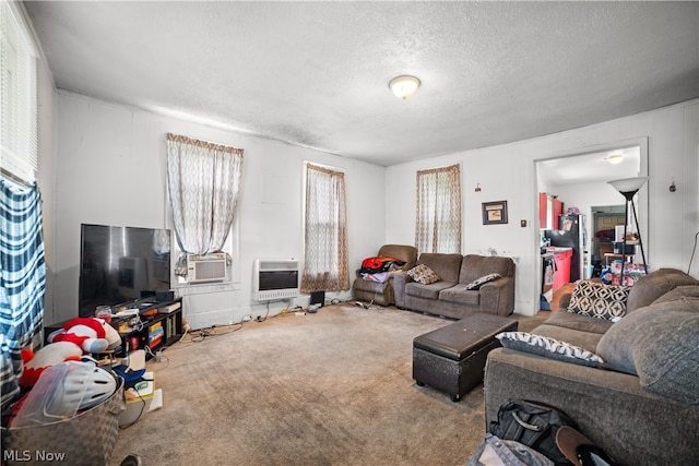 carpeted living room with a textured ceiling, cooling unit, and plenty of natural light