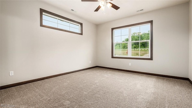 carpeted spare room with ceiling fan