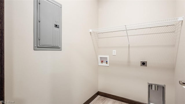 laundry area featuring electric dryer hookup, hookup for a washing machine, wood-type flooring, and electric panel