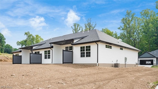 rear view of house with central AC unit