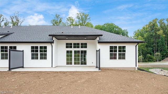 back of property with a patio