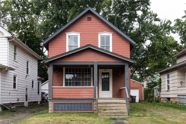 bungalow-style home with a front yard and covered porch